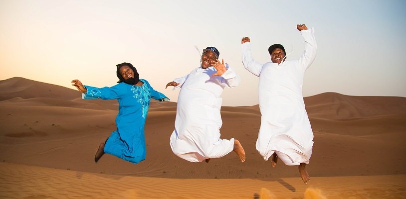Three expats jumping in the air