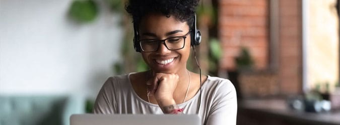 Online private high school student smiling at laptop