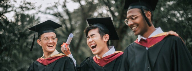 Three online high school students graduating and celebrating together